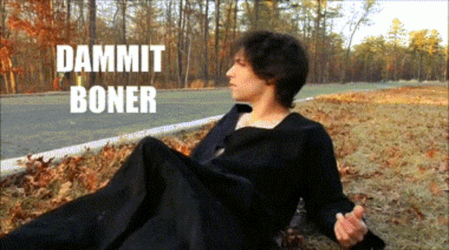 a man in a black robe is laying on the ground with the words dammit boner behind him