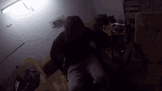 a person in a dark room with a sign on the wall that says ' a ' on it