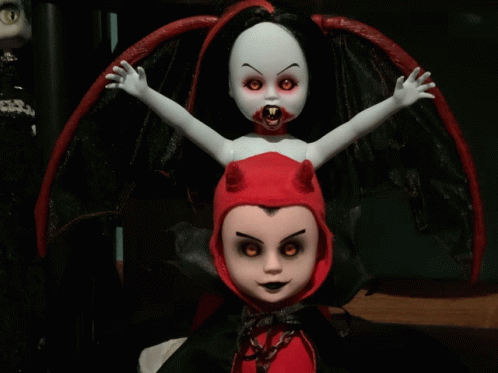 a vampire doll with red eyes and red horns