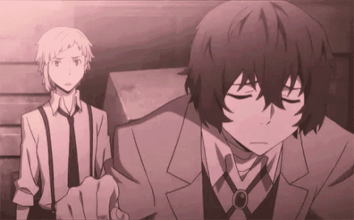 a couple of anime characters are standing next to each other .