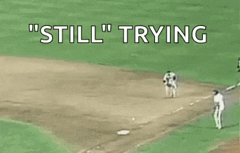a referee is pointing at a baseball player who is trying to steal the base .