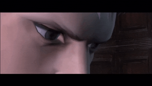a close up of a person 's face with a serious look on their face