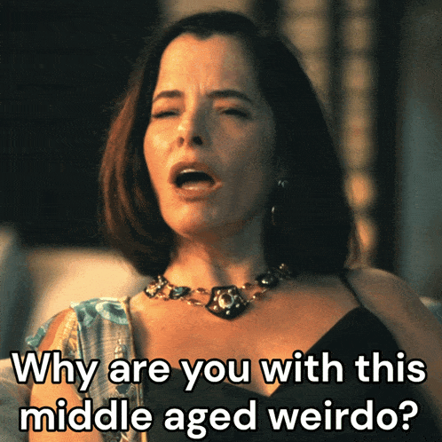 a woman with a necklace says why are you with this middle aged weirdo