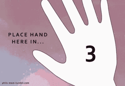 a person is covering their face with their hand in a living room .