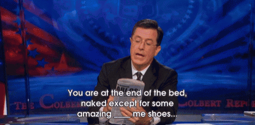 a man in a suit and tie is holding a roll of toilet paper and says " you are at the end of the bed "
