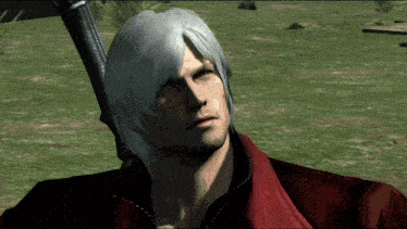 a man with white hair and a red jacket stands in a grassy field