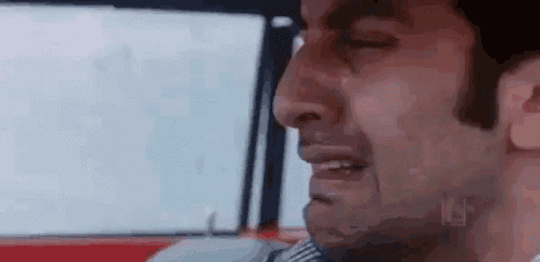a close up of a man 's face with his eyes closed in a car .