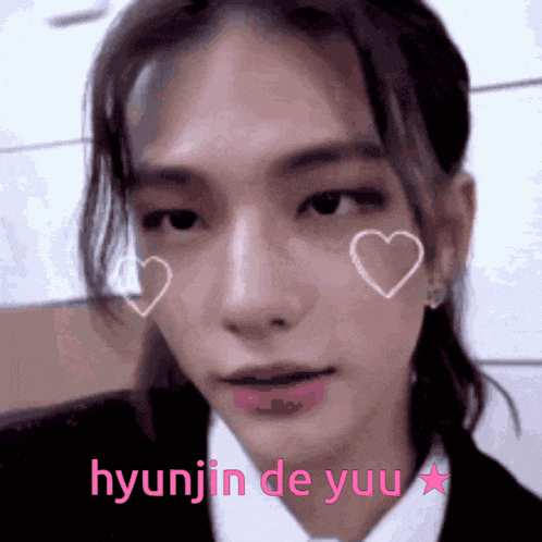 a close up of a person 's face with hearts on it and the name hyunjin de yuu written in pink .