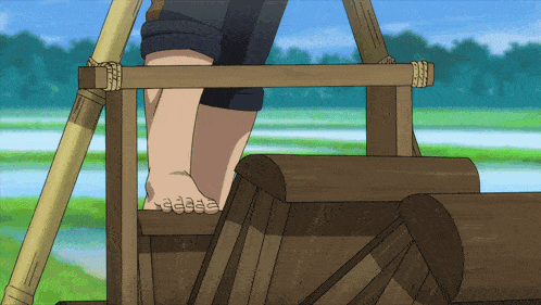 a person 's feet are shown standing on a wooden platform