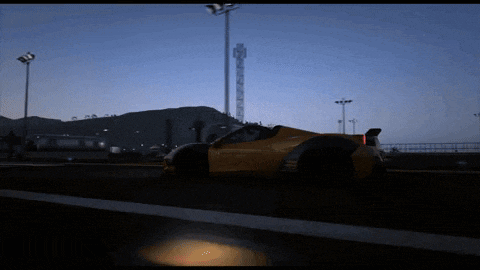 a yellow sports car is parked on the side of the road