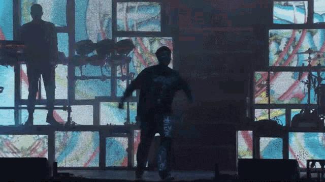 a man on stage with a shirt that says ' nirvana ' on it