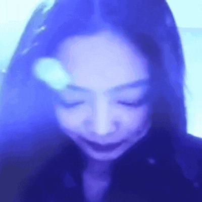 a close up of a woman 's face with her eyes closed in front of a blue background .
