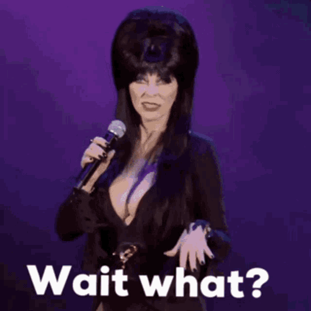 a woman holding a microphone with the words wait what written below her