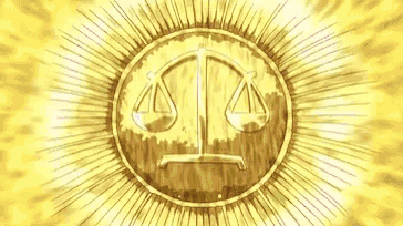 a close up of a gold coin with a scale of justice on it .