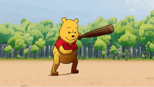 winnie the pooh is holding a baseball bat on a baseball field