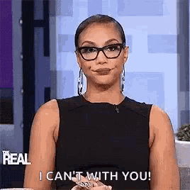 a woman wearing glasses is making a funny face and saying `` i can 't with you ! ''