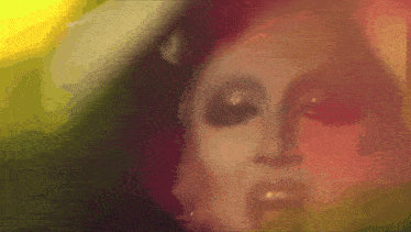a close up of a woman 's face with a lot of makeup on .