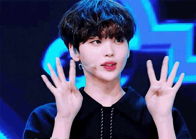 a young man making a funny face with his hands