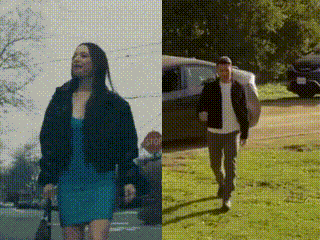 a woman in a blue dress and a man in a black jacket are walking next to a stop sign