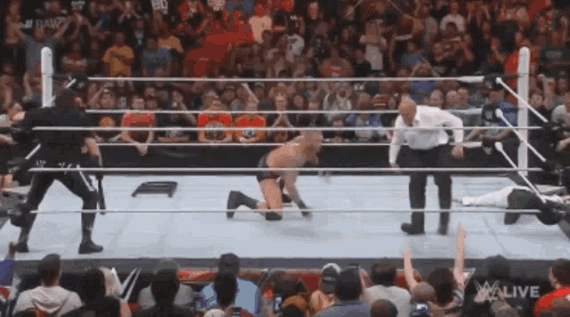 a man in a wrestling ring with the word w live on the bottom right