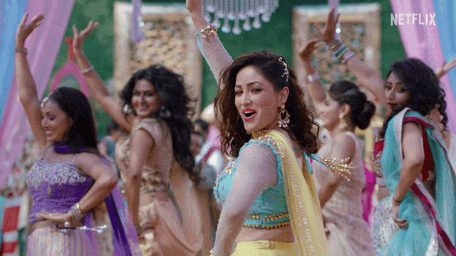 a group of women are dancing in front of a sign that says netflix on it