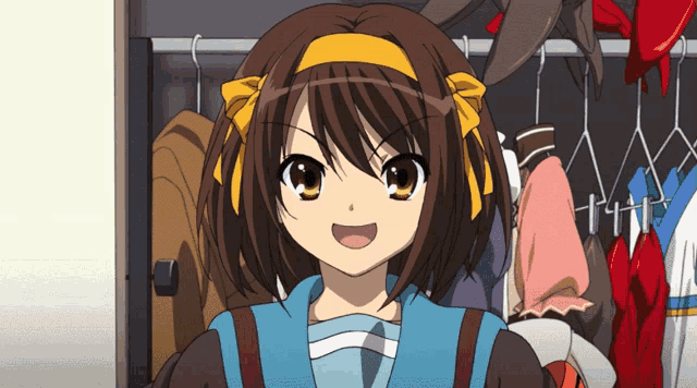 a girl with brown hair and a yellow headband stands in a closet