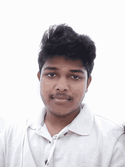 a young man wearing a white shirt looks at the camera with a white background