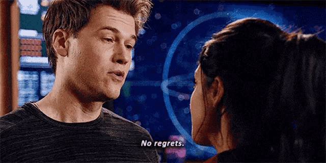 a man and a woman are looking into each other 's eyes and the man is saying `` no regrets '' .
