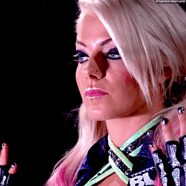 a close up of a woman 's face with a bl logo on her sleeve