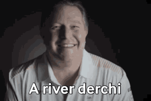 a man in a white shirt is smiling with the words a river derchi behind him