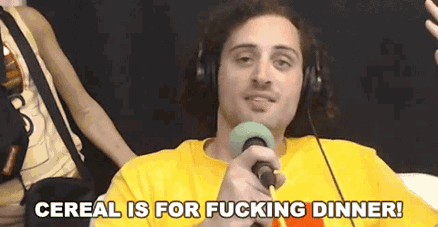 a man wearing headphones and holding a microphone says cereal is for fucking dinner