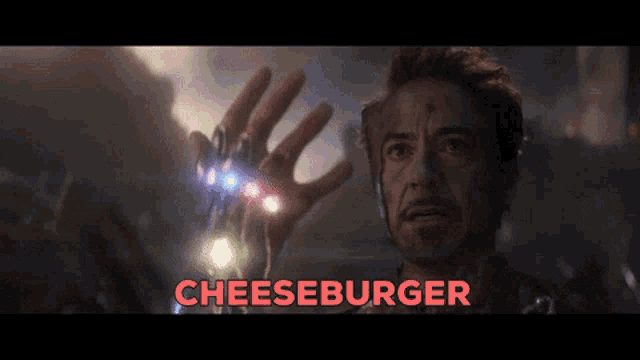 a man is holding up his hand with the word cheeseburger written above him