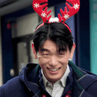 a man wearing a headband with reindeer antlers and snowflakes on it