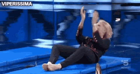 a woman is laying on a trampoline with the words viperissima behind her