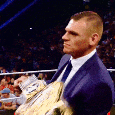 a man in a suit and tie holding a trophy
