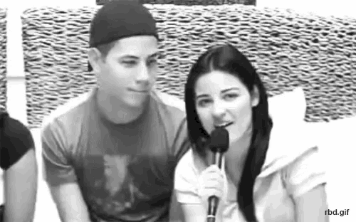 a black and white photo of a man and a woman with a microphone
