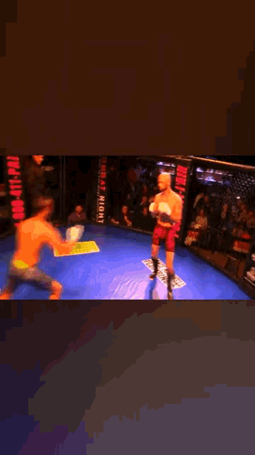a man is laying on the ground in a boxing ring with a sign that says fight night