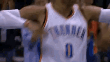 a close up of a basketball player with his arms outstretched during a game .