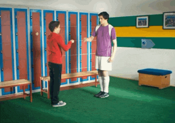 two boys in a locker room talking to each other