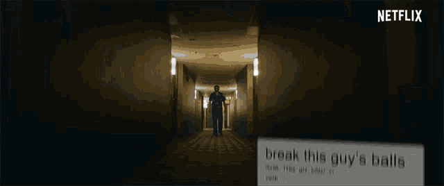 a man is walking down a hallway next to a netflix logo
