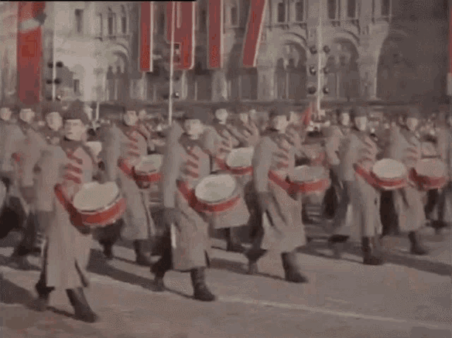 a marching band is playing drums in front of a sign that says ' russia ' on it