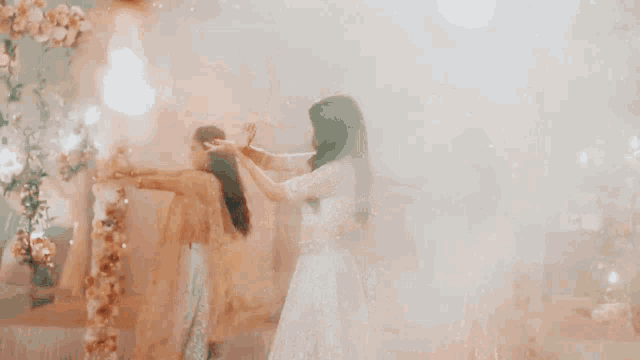 a woman in a white crop top is dancing with her arms outstretched