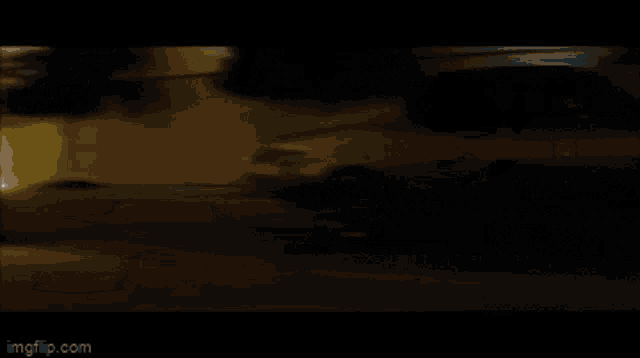 a blurry picture of a car driving down a road at night .