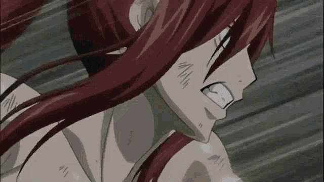 a close up of a person 's face with red hair in a fairy tail anime .