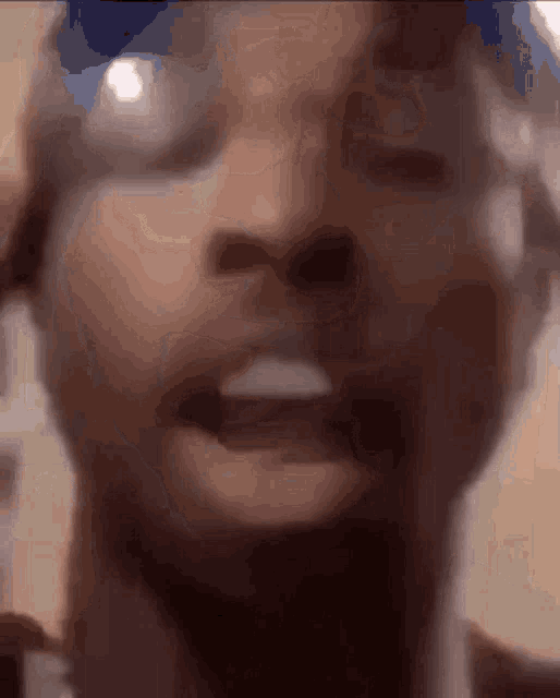 a close up of a person 's face with their mouth open