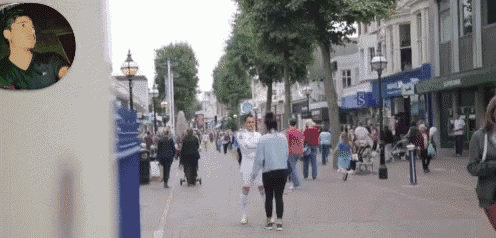 a man in a black jacket is driving down a street with a sign that says ' m & s ' on it