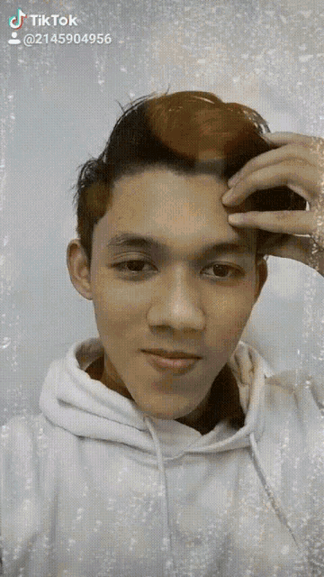 a young man 's face is shown with a tiktok watermark on the bottom