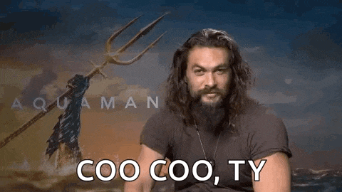 a man with a beard is pointing at the camera with a trident .