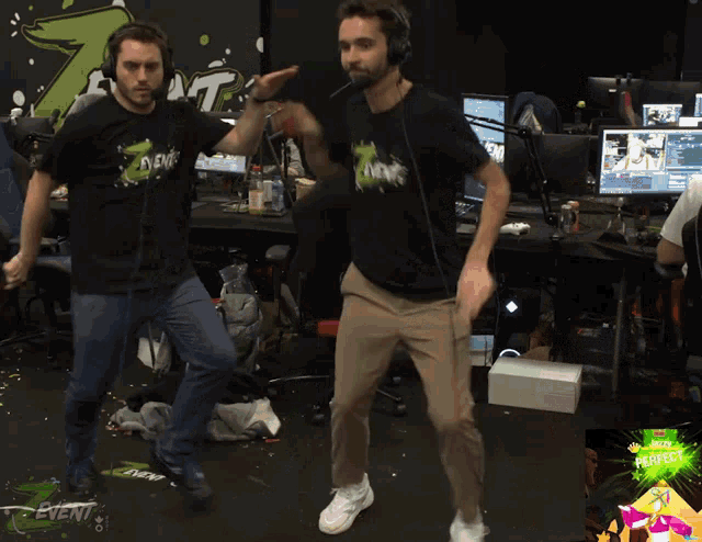 two men are dancing in front of a sign that says " event "