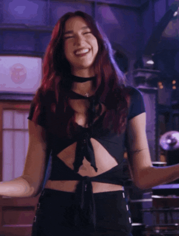 a woman with red hair wearing a choker and a crop top